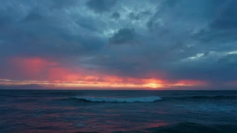Drone flies low over the waves during sunset with blue clouds. Stock Footage 305828039