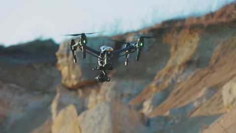 Drone flies moving around on background rock. Modern technologies for shooting Stock Footage 175401357