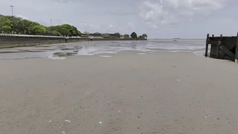 Drone flies from muddy low tide on Amazon River next to Rampa St Ines Stock Footage 290928736