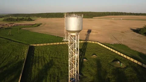 The drone flies near the water tower. Don is flying near a water tank in a field Stock Footage 196957341