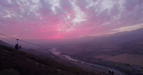 The drone flies next to the cabins of the funicular in the mountains, next to a Stock Footage 255880819