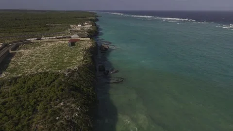 Drone flies north at high tide on a sunny afternoon along Mtende Beach Stock Footage 344111338