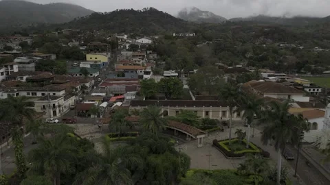 Drone flies north over central park in downtown Copan, Honduras on cloudy day Stock Footage 306615113