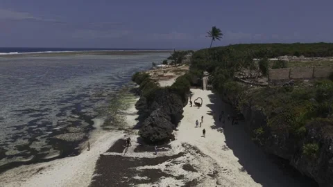 Drone flies north over staircase leading down to the sand Видео 344048662