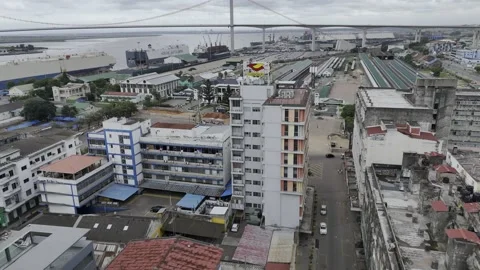 Drone flies northwest toward train station at Worker's Square next to river Stock Footage 333842092