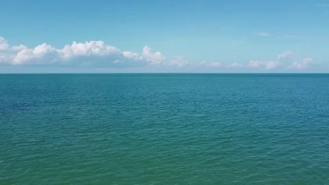 A drone flies into the open sea over turquoise water Stock Footage 147528352