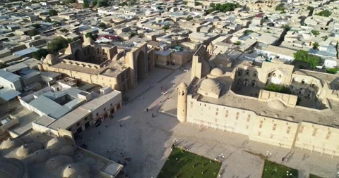 Drone flies over ancient complex Lyab-i Hauz surrounded by old Bukhara Stock Footage 264087994
