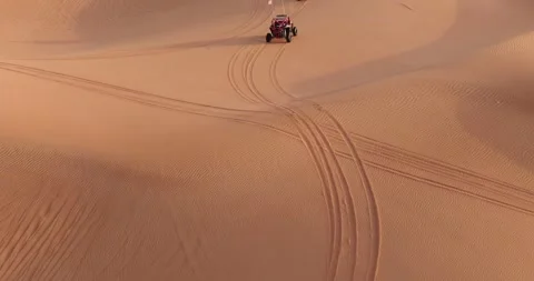 A drone flies over ATVs training in the desert sands in the UAE Stock Footage 246949379