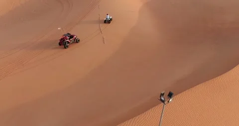 A drone flies over ATVs training in the desert sands in the UAE Stock Footage 277267893