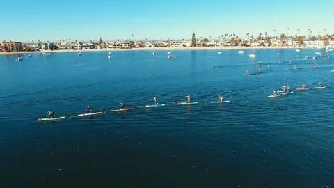 Drone flies over the begining of a Mission Bay SUP Race in San Diego Video stock 103774133