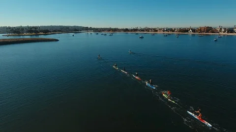 Drone flies over the beginning of a Mission Bay SUP Race in San Diego Video stock 103769929