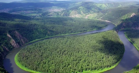 A drone flies over a bend in a river Stock Footage 172102821