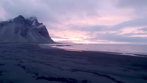 Drone Flies Over Black Sand Beach Purple Sunset in Stokksnes Iceland Stock Footage 258508761