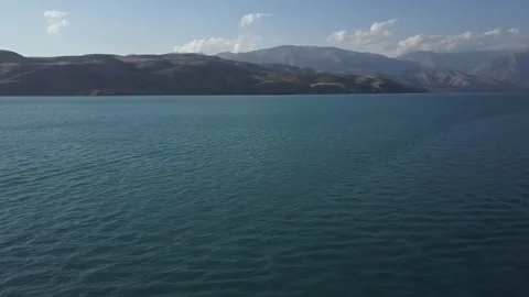 A drone flies over a blue mountain lake. Sunny summer day Stock Footage 334607055