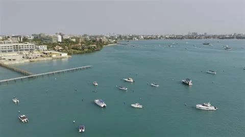 Drone flies over boats toward shore off Masani Bay on sunny day Stock-Footage 342283452