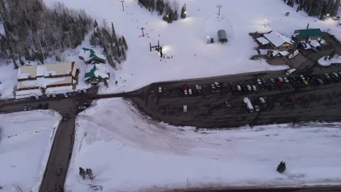 Drone flies over Brians Head Ski Resort with Night Time Skiers and Snowboarders Stock Footage 142333113