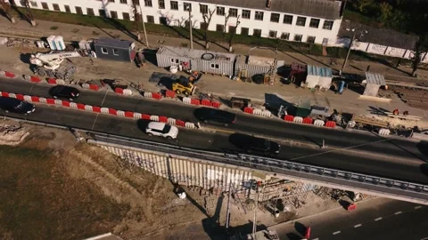 The drone flies over the bridge over the road being repaired by builders Stock Footage 190361835