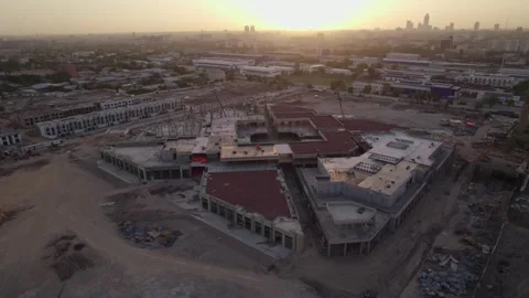 Drone flies over buildings under construction on a sunny day Stock Footage 271060264