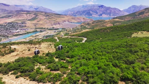 The drone flies over the cabins of a mountain funicular. Sunny summer day. There Stock Footage 311697137