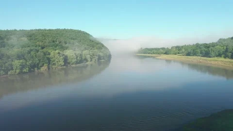 The drone flies over the calm current of the river. Filmed in UHD 4k video. Video stock 171530722
