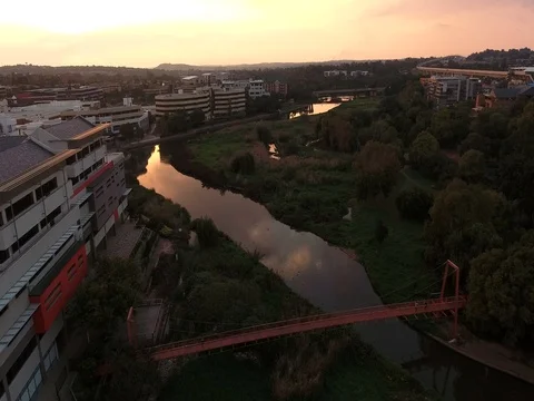 Drone flies over Centurion Lake in Gauteng at sunset 스톡 동영상 80720986