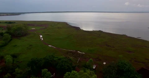 The drone flies over a clearing and reaches a lake in Africa, Mali Stock Footage 67488082