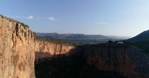 Drone flies over cliff and deep stone wall Stock Footage 124221197