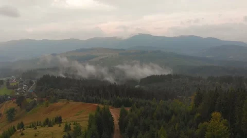 Drone flies over clouds on sunny day, summer mountain peaks on horizon. Stock Footage 197501160