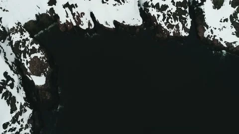 The drone flies over the coast of the Arctic Ocean, the rocks are covered with Stock Footage 169463853