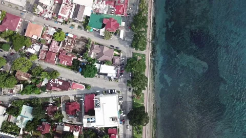 Drone flies over the coastline of a small port city in Asia Stock Footage 99162871