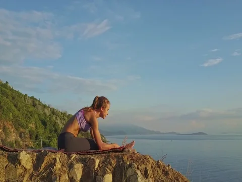 Drone Flies over Concentrated Girl Does Asanas on Large Stone Stock Footage