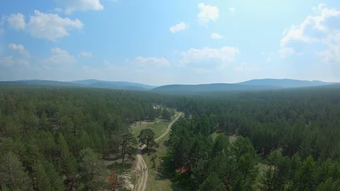 Drone flies over a couple walking on a country road Stock Footage 108784269