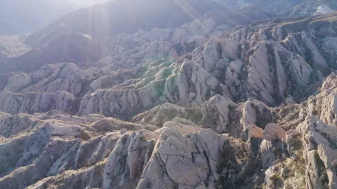 A drone flies over the dramatic landscape of the Devil's Punchbowl at Stock Footage 280132462