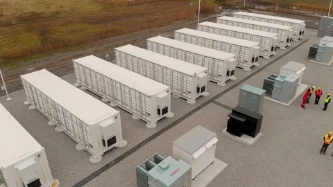 Drone flies over energy storage containers at utility site Stock Footage