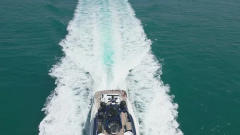 A drone flies over an expensive private yacht sailing on a calm sea against the Stock Footage 248585324