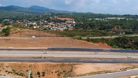 The drone flies over the field towards the high-speed highway. Stock Footage 125643334