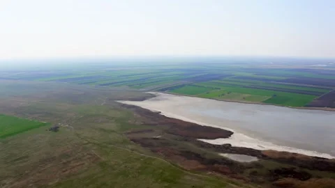 Drone flies over fields towards lake in summer in nature reserve Slano Kopovo Stock Footage 270501892