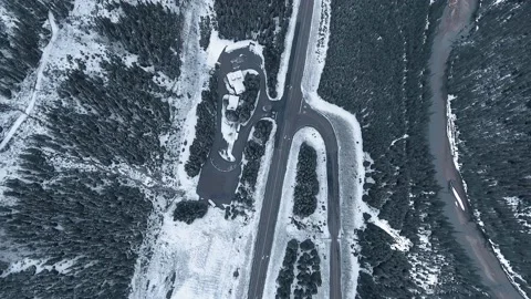 Drone flies over forest road in the middle of winter in snowfall in Alberta Stock Footage 143233431