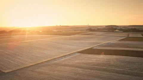 Drone flies Over Frosty Patchwork Fields at Golden Hour 4K Stockbeeldmateriaal 328227842