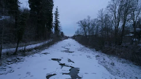 A drone flies over a frozen river in winter Stock Footage 266895056