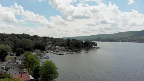 Drone flies over gorgeous lake to boat dock Stock Footage 135691576
