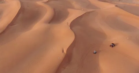 The drone flies over a group of ATVs standing on the desert sand Stock Footage 249711853