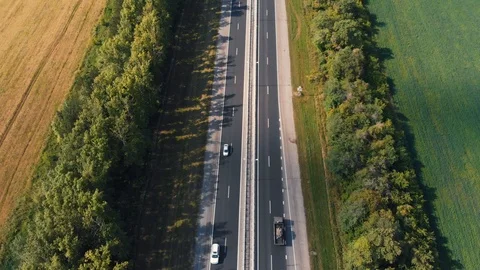 The drone flies over the highway on which the cars go Stock Footage 94694293