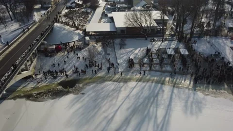 Drone flies over the hole in the winter river, people enter the cold water, Stock Footage 222062249