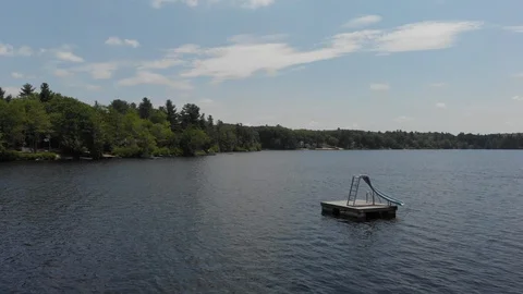 Drone Flies Over Lake with Dock and Trees Vídeo Stock 92178164