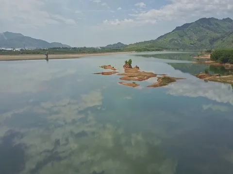 Drone Flies over Land Plot Located among Lake against Jungle Stock Footage 80075311