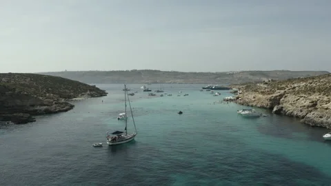 Drone flies over large group of people swim in the sea in crystal clear water 스톡 동영상 136670130