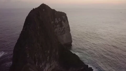 The drone flies over a large mountain and the sea in Indonesia. Stock Footage 155987635