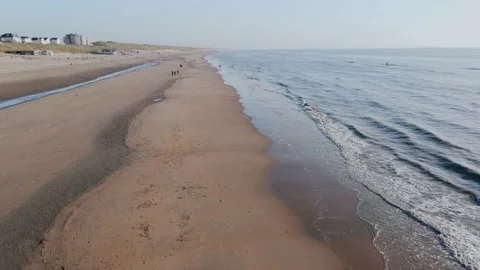 Drone flies over long ocean shore outside city on a summer day Video stock 196836879