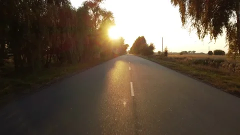 Drone flies over the median strip, the highway, the setting sun Stock Footage 174061663